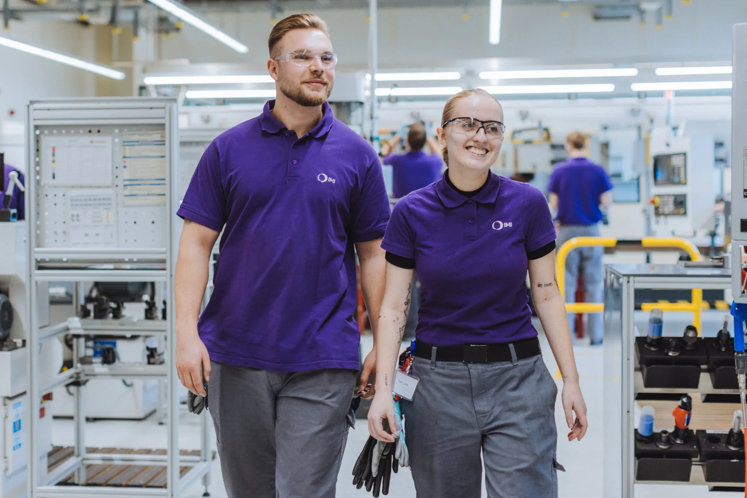 Two IMI staff walking together around our offices