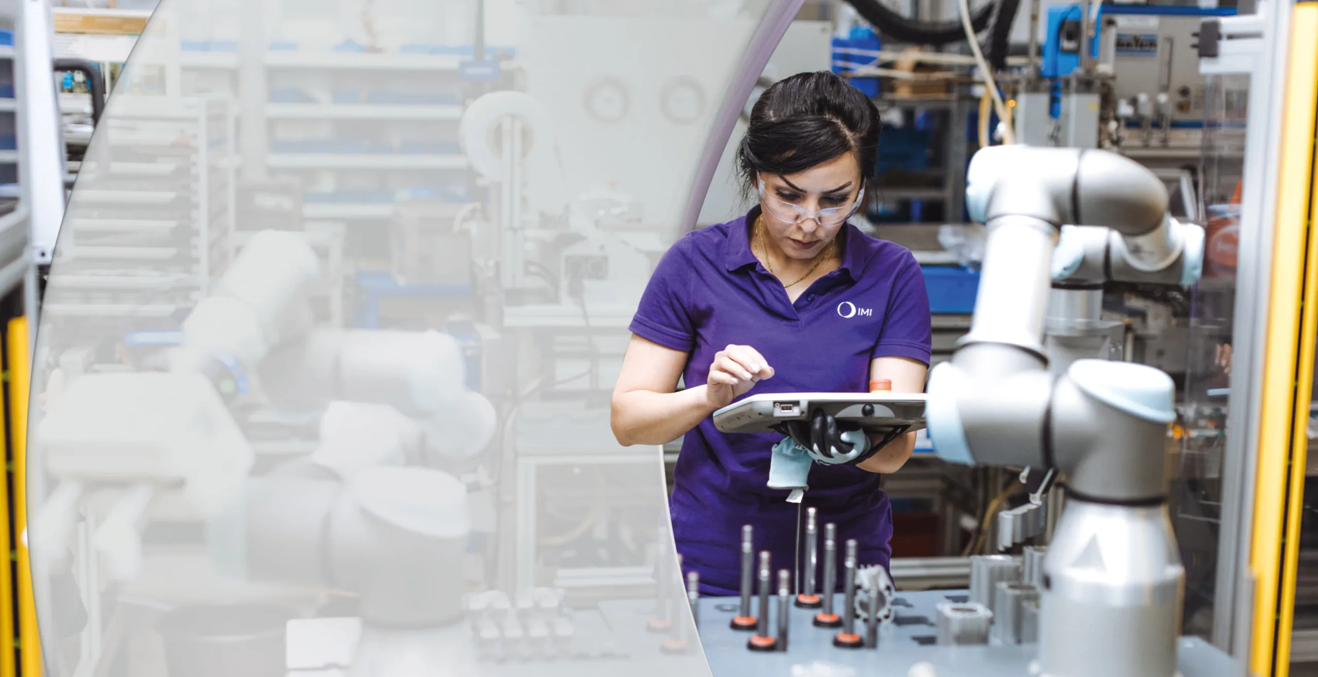IMI staff member conducting quality testing on components